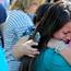 A woman is comforted as friends and family wait for students at the local fairgrounds after a shooting at Umpqua Community College in Roseburg, Ore., on Thursday, Oct. 1, 2015.   (AP Photo/Ryan Kang)