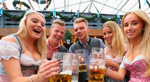 MUNICH, GERMANY - SEPTEMBER 19: Revelers raise their beer glasses at the Schottenhamel beer tent on the opening day of the 2015 Oktoberfest on September 19, 2015 in Munich, Germany. The 182nd Oktoberfest will be open to the public from September 19 through October 4 and will draw millions of visitors from across the globe in the world's largest beer fest.  (Photo by Alexander Hassenstein/Getty Images)